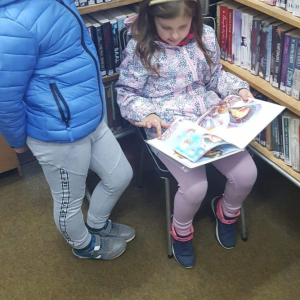 Chłopiec i dziewczynka, dziewczynka czyta książkę
